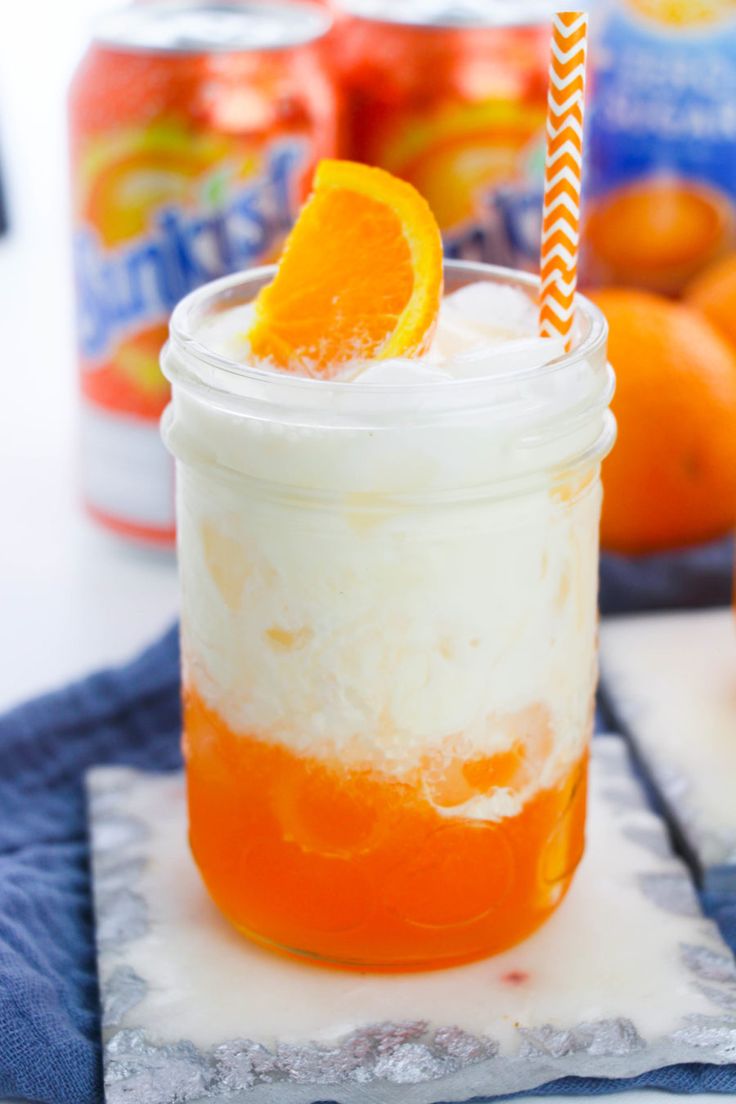 an orange and white drink in a mason jar