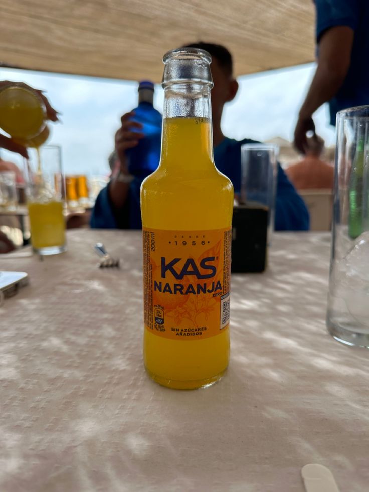 a bottle of orange juice sitting on top of a table