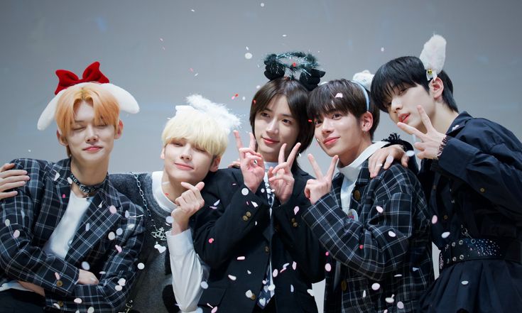 group of young men standing next to each other with confetti in front of them