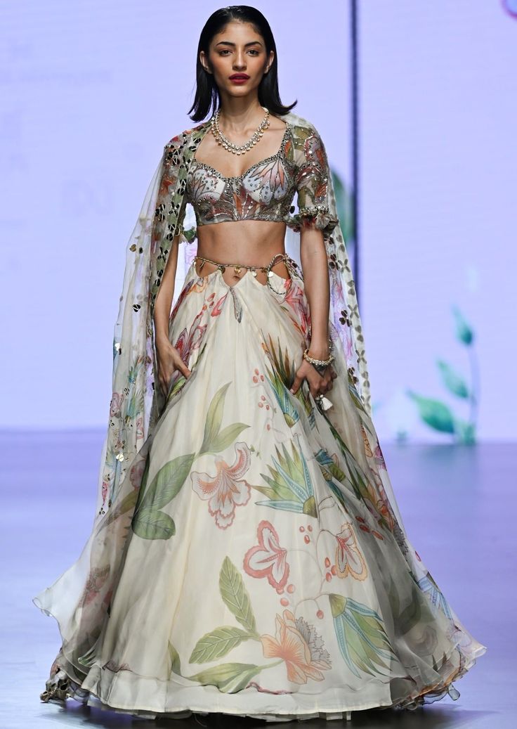 Printed embroidered blouse with lehenga dupatta. Luxury Designer Lehenga With Printed Motifs, Luxury Unstitched Lehenga With Printed Motifs, Luxury Art Silk Choli With Motifs, Luxury Long Sleeve Choli With Floral Embroidery, Anarkali Style Pre-draped Floor-length Saree With Floral Embroidery, Embroidered Lehenga With Cape Sleeves In Organza, Organza Choli With Zari Work And Cape Sleeves, Organza Choli With Cape Sleeves And Zari Work, Festive Embroidered Lehenga With Cape Sleeves