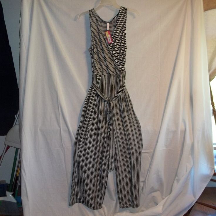 Xhiliration Sleeveless V-Neck Jumpsuit. Brand New With Tags. Wrap Style V-Neck, Also Come With Two Front Pockets And Waist Tie Strap. Black/White Strip Pattern. 66% Polyester/33% Raylon/ 1% Spandex Pp1 Casual Striped V-neck Jumpsuits And Rompers, Sleeveless Striped Jumpsuits And Rompers For Loungewear, Striped Sleeveless Jumpsuits And Rompers For Loungewear, Striped Sleeveless Jumpsuit For Loungewear, Striped Sleeveless Jumpsuits And Rompers For Spring, Sleeveless Striped Jumpsuits And Rompers For Spring, Striped Sleeveless Jumpsuit For Spring, Teal Jumpsuit, Bohemian Rompers