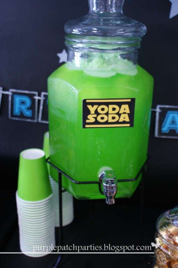 a green beverage dispenser sitting on top of a table