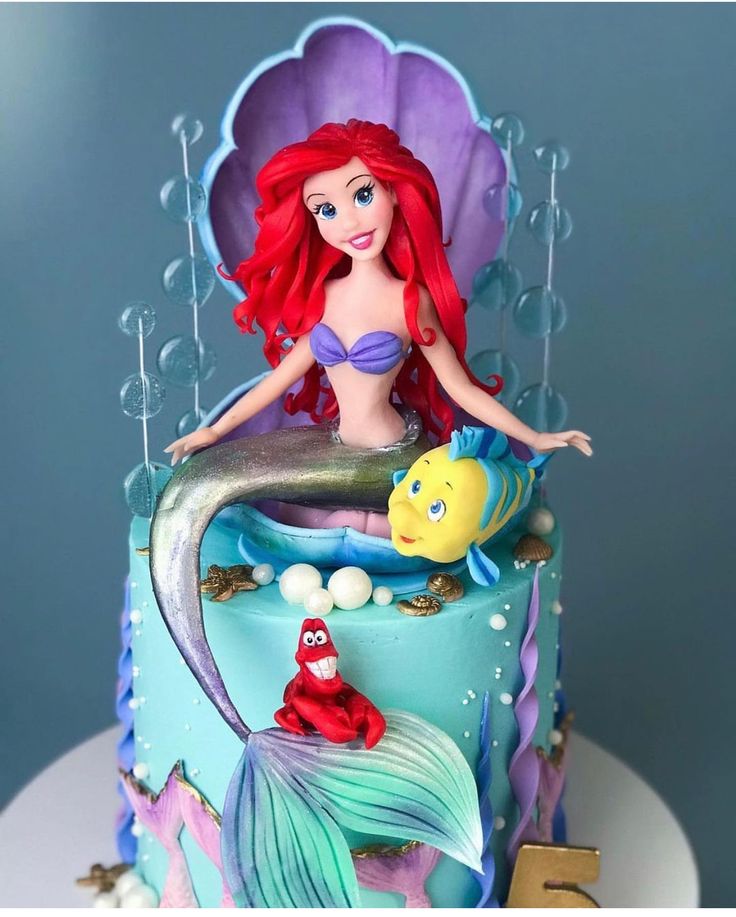 the little mermaid cake is decorated with fondant