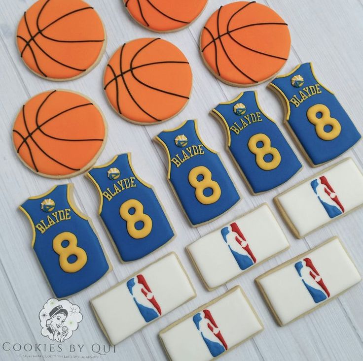 cookies decorated to look like jerseys and basketballs are arranged in front of each other