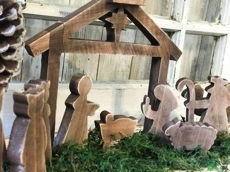 a nativity scene made out of wood and moss