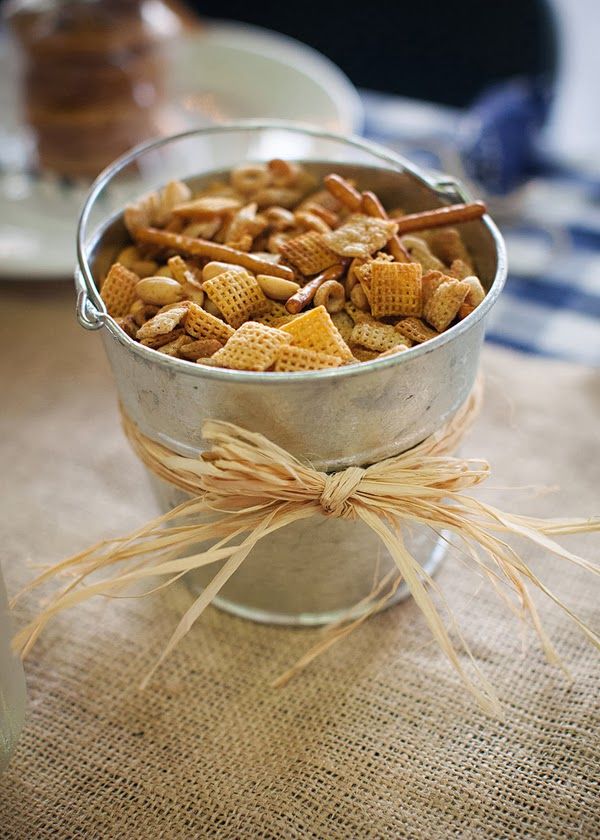 a metal bowl filled with corn flakes on top of a table