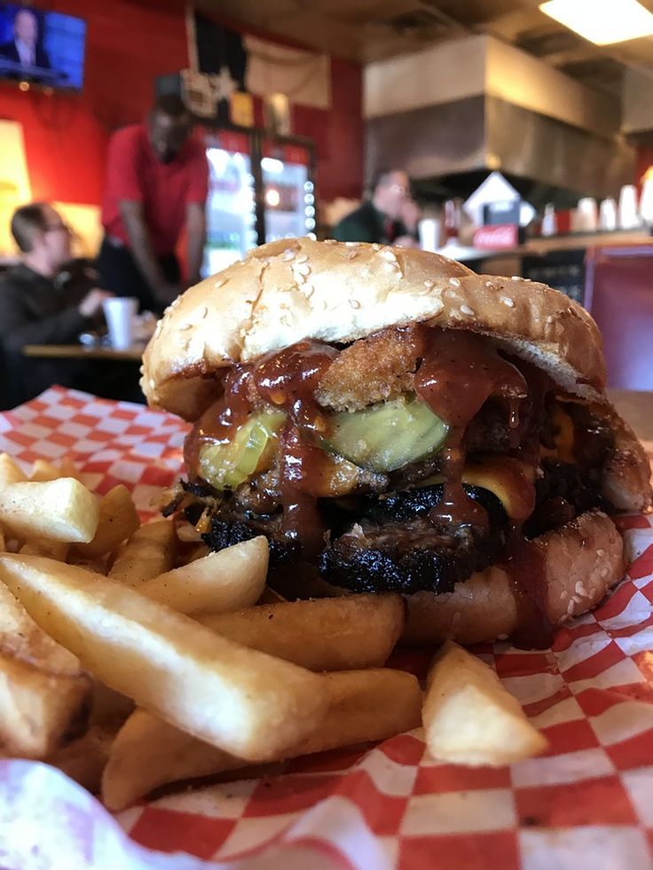 a close up of a sandwich and fries on a table