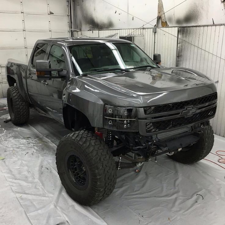 a large silver truck parked in a garage