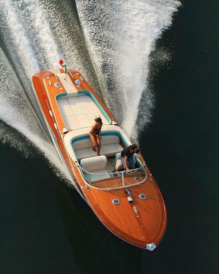 two people on a motor boat in the water