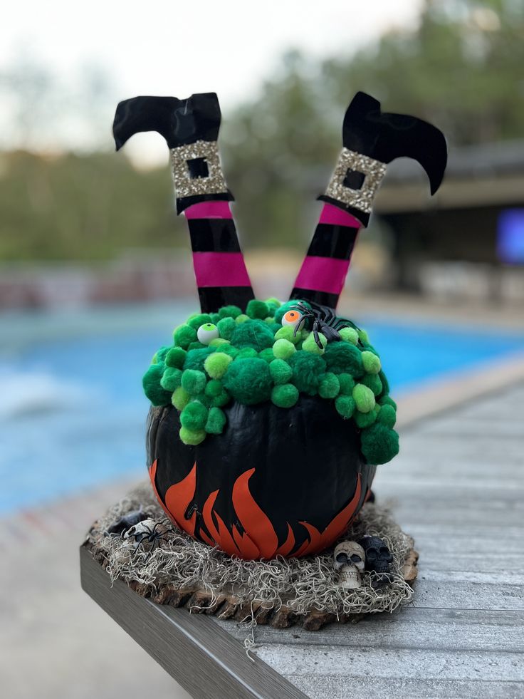 a decorated pumpkin sitting on top of a wooden table