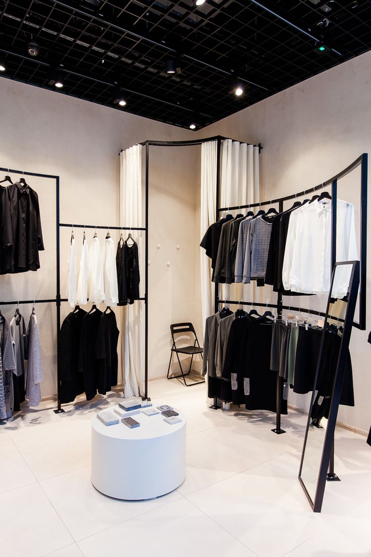 a clothing store with black and white clothes on racks