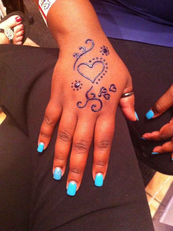 a woman's hand with blue and black designs on it