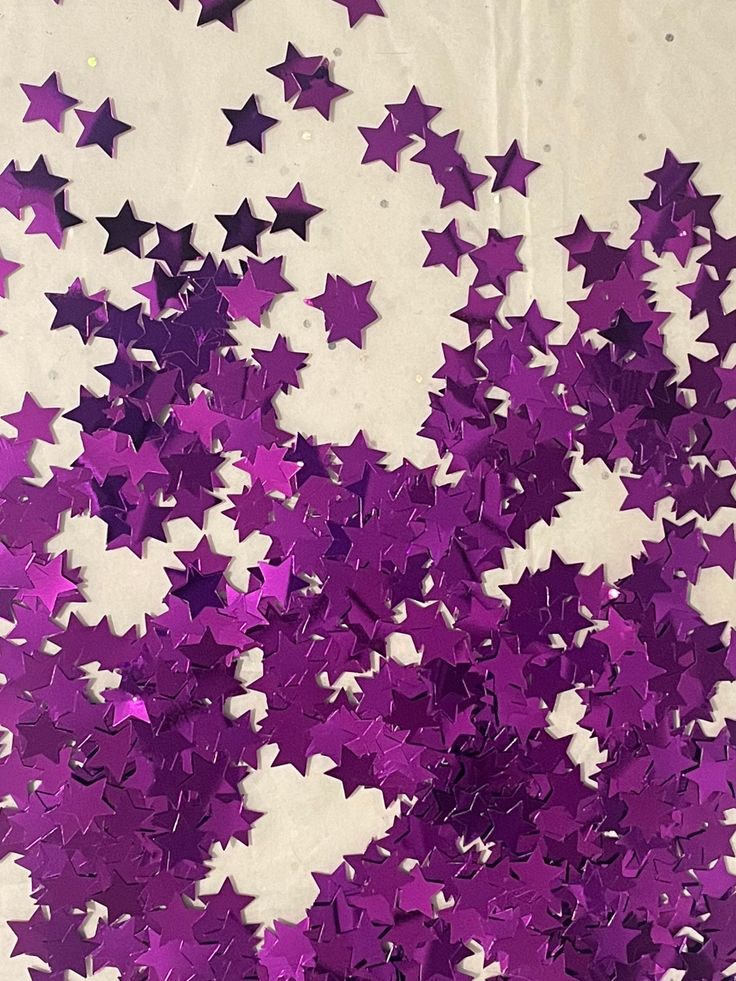 purple and white stars are scattered in the air