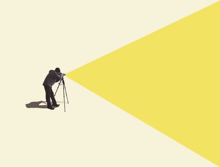 a man standing in front of a yellow and white background with a camera on his tripod