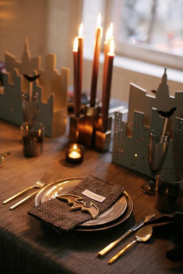 a table set with place settings and candles