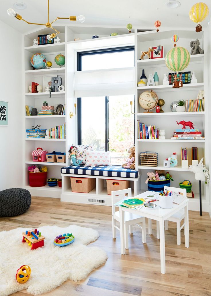 a child's playroom with toys and bookshelves