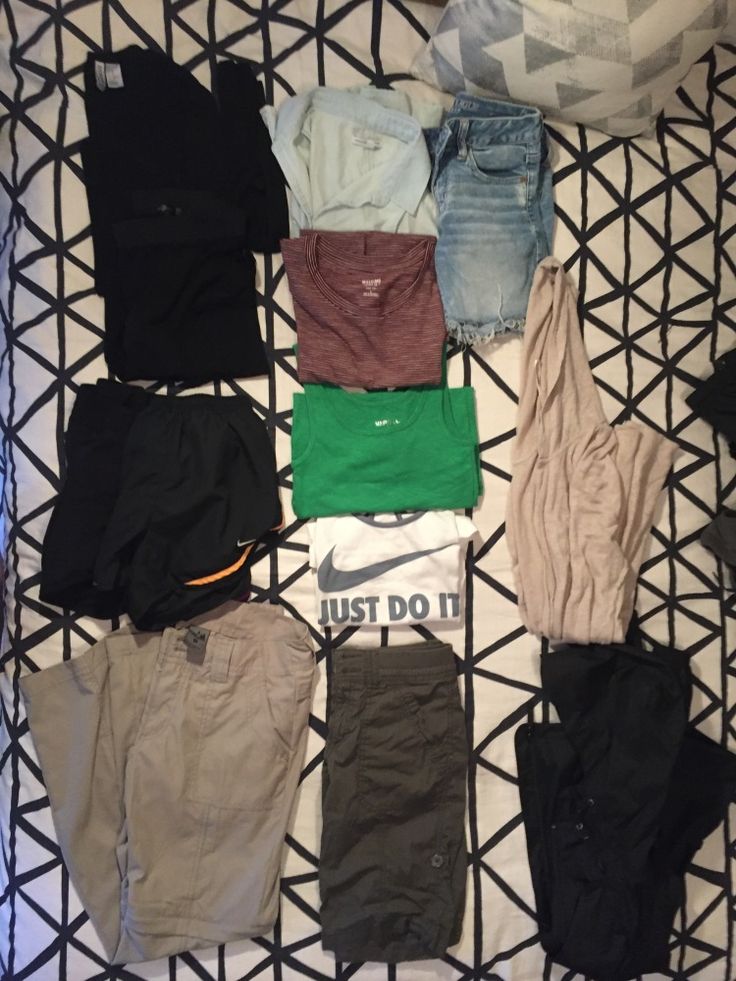 there are many pairs of pants on the bed together, all in different colors and sizes