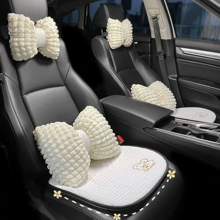 the interior of a car with two white bows on it's headrests