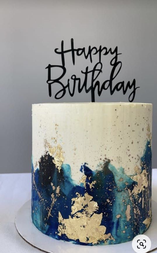 a blue and white birthday cake with the words happy birthday on it's top