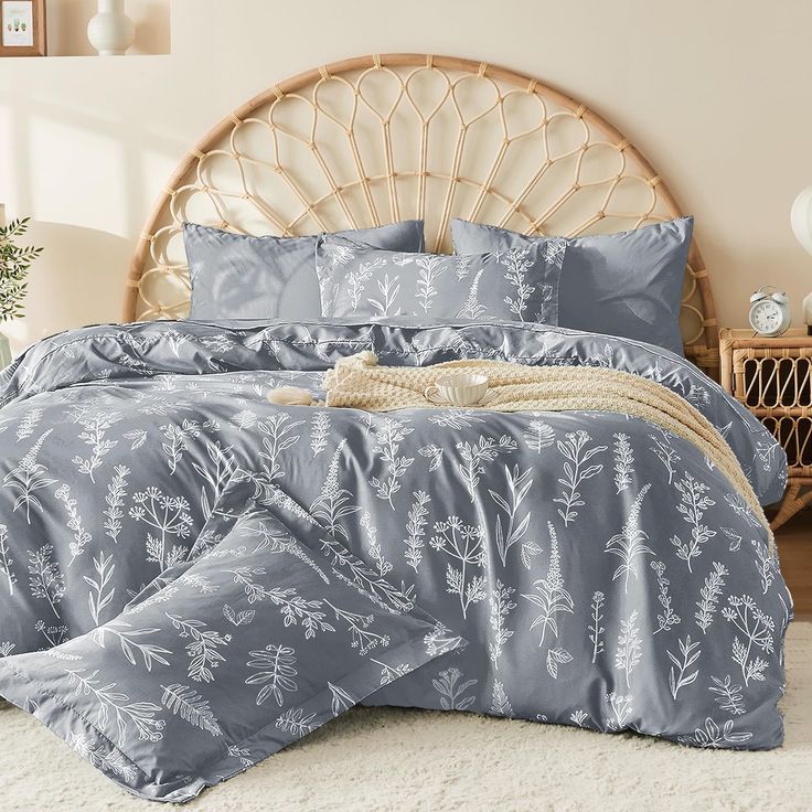 a bed with blue comforters and pillows in a room