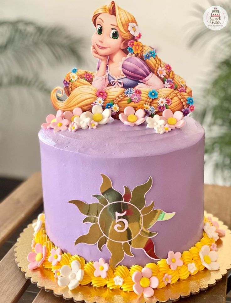 there is a purple cake with a little princess on top and flowers around the edges