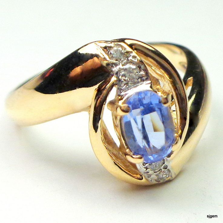 Elegant Style, Genuine, 14k Solid Yellow Gold Ring, with .50ct. Oval Cut Tanzanite in Lavender Blue color, and genuine Diamonds. The oval shaped center stone is 6mm x 4mm and the face of the ring is about 13mm long by 10mm wide. This Awesome Estate ring is a size 5 3/4 Ring, resizable by your local jeweler, if need be. It weighs 3.7grams, tested and Hallmarked 14k. Accented with 4 points of round cut diamond accents, prong set in white gold atop a yellow gold mount with a gorgeous free form desi Oval Tanzanite Birthstone Ring With Accent Stones, Formal Oval Tanzanite Birthstone Ring, Oval Tanzanite Diamond Ring For Anniversary, Yellow Gold Tanzanite Birthstone Ring For Anniversary, Oval Tanzanite Birthstone Ring, Oval Tanzanite Diamond Ring For Gift, Oval Tanzanite Diamond Ring As A Gift, Lavender Blue Color, Plant City