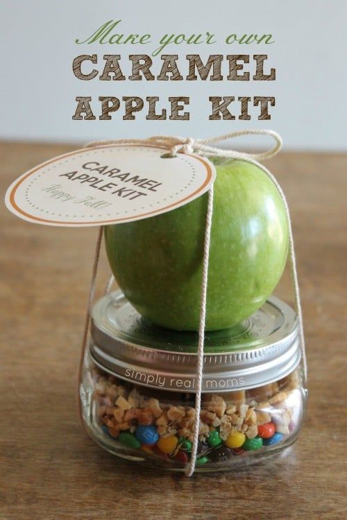 an apple sitting in a jar with candy inside it and the words make your own caramel apple kit