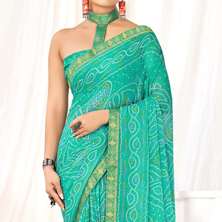 Turquoise colored saree is made from chiffon fabric which is highlighted with beautiful bandhani printed work as shown. Comes along with unstitched chiffon blouse piece which you can customise as per your design/style. Occasion - You can wear this saree for casual and daily wear. Note:- the actual product may differ slightly in color and design from the one illustrated in the images when compared with computer or mobile screen. Measurements: Saree : Chiffon : 5.5 Mtrs Blouse : Chiffon : 0.8 Mtr Material: Chiffon Stitch Type: Unstitched Country of Origin: India Care Guide: Dry Clean Printed Chiffon Saree, Saree Chiffon, Blouse Chiffon, Mobile Screen, Chiffon Saree, Georgette Sarees, Chiffon Blouse, Print Chiffon, Turquoise Color