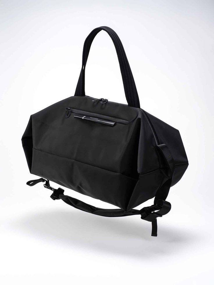 The SANNA is the ideal travel companion for those who are planning a multi-day trip and require both adequate storage space and comfort. Taking on the form of a duffle bag, the SANNA can be carried in a number of ways, either using the shoulder strap or carry handles. Black buckles on the exterior are used to hold the shoulder straps in place when they are not in use. Functional Duffle Bag With Removable Pouch Tote, Large Capacity Nylon Satchel For On-the-go, Functional Tote Duffle Bag For Daily Use, Modern Nylon Rectangular Gym Bag, Modern Weekender Bag With Top Carry Handle For Trips, Functional Travel Bag With Removable Pouch For Weekend Trips, Versatile Travel Bag For Weekend Trips, Functional Tote Shoulder Bag For Overnight Trips, Travel Gym Bag With Removable Pouch Tote