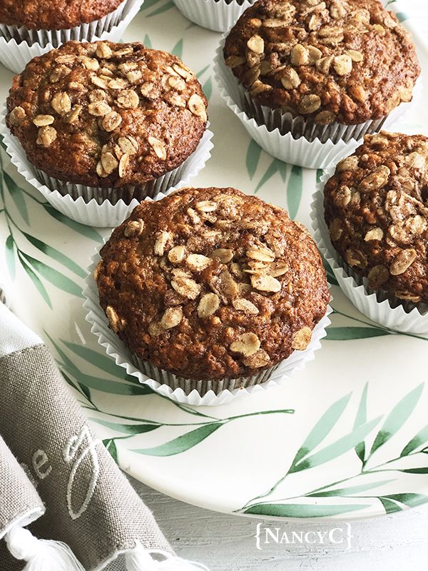 several muffins are on a plate with leaves