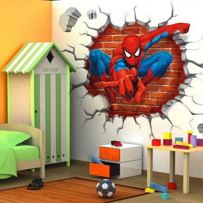 a bedroom with a spiderman wall sticker on the wall and a child's bed