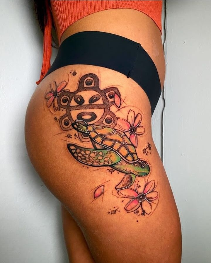 a woman's thigh with a tattoo design on it