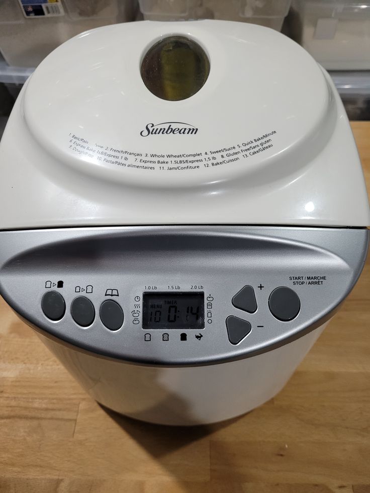 a white blender sitting on top of a wooden table