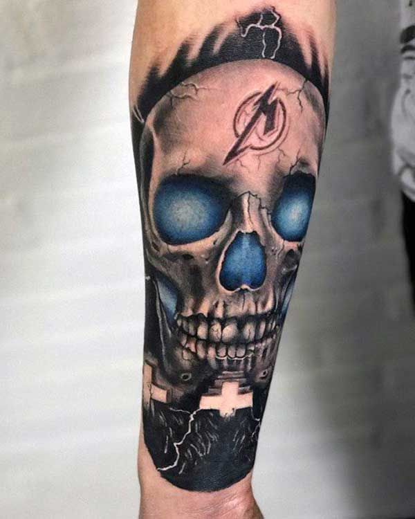 a man's arm with a skull and lightning bolt on it