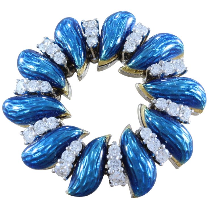 A classic piece by Tiffany & Company, this wreath brooch features 30 VVS quality full-cut diamonds, approximately 1.25 carat, accented by vivid blue enamel. The wreath is made in 18K white gold and signed Tiffany & Co Italy. Dimensions: 1.25 x 1.25 inch Royal Blue Jewelry, Tiffany And Co Jewelry, Fish Brooch, Tiffany Diamond, Gold Brooch, Tiffany Jewelry, Antique Brooches, Diamond Brooch, Gold Brooches