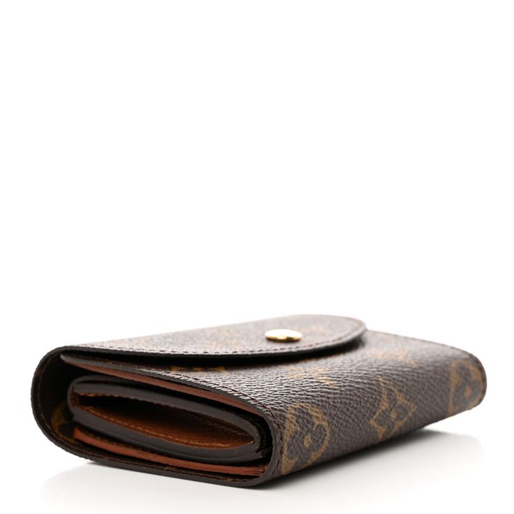 This is an authentic LOUIS VUITTON Monogram Helene Wallet. This chic compact wallet is crafted of Louis Vuitton monogram coated canvas in brown. The wallet unsnaps to a brown crossgrain leather interior with card slots, patch pockets, a billfold, and a monogram coated canvas flap compartment. A Monogram, Compact Wallet, Louis Vuitton Wallet, Leather Interior, Authentic Louis Vuitton, Louis Vuitton Monogram, Patch Pocket, Card Slots, Slots