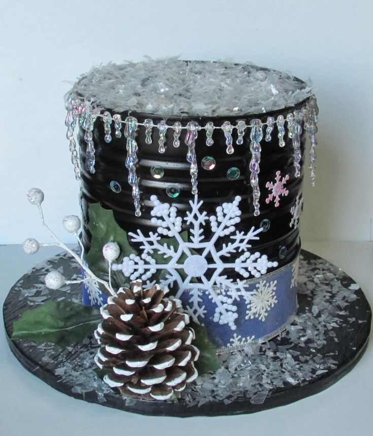 a black hat with snowflakes on it and a pine cone