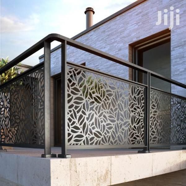 an outdoor balcony with metal railings and decorative screens on the side of the house