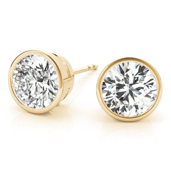 Every pair of Bezel Solitaire Round Diamond Studs is gracefully adorned with a lab-grown diamond, set in a timeless bezel setting for an understated modern look. Exquisitely crafted from luxurious 14k white or yellow gold, these earrings will add an elegant and classic touch to any ensemble. Bezel Set Diamond Earrings, Solitaire Bands, Diamond Earrings Studs Round, Yellow Gold Wedding Ring, Solitaire Earrings, Solitaire Studs, Bezel Set Diamond, Radiant Diamond, Diamond Stud Earrings