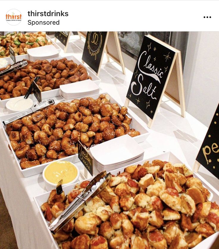 there are many different types of food on the buffet table at this event, including breads and pastries