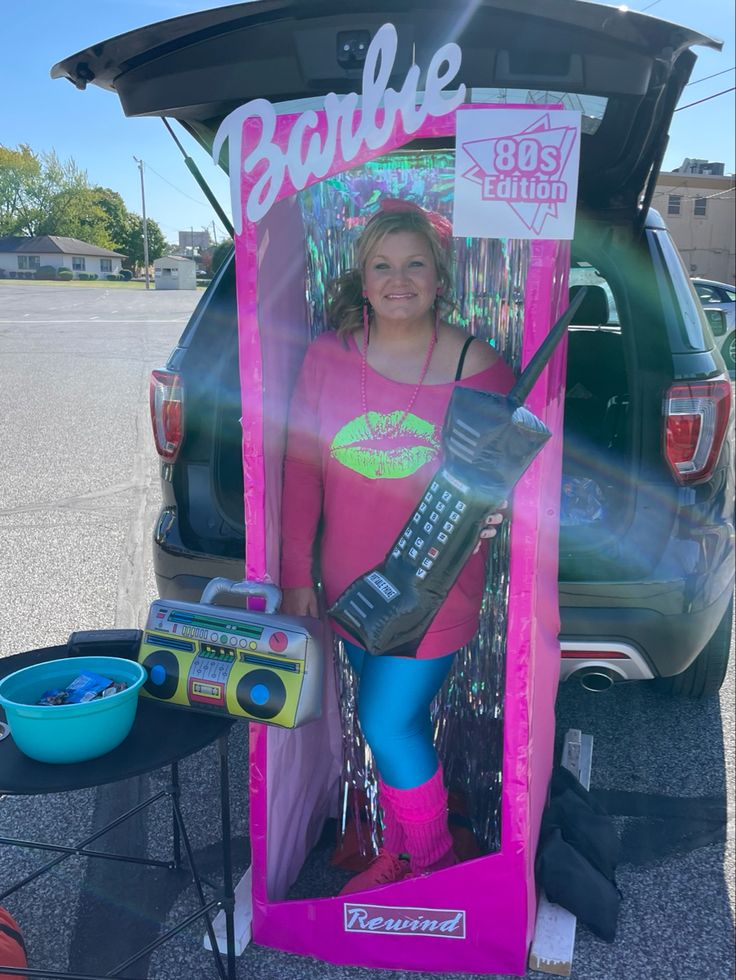 a woman in pink shirt standing next to a radio