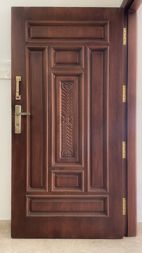 a close up of a wooden door with decorative designs on the front and side panels