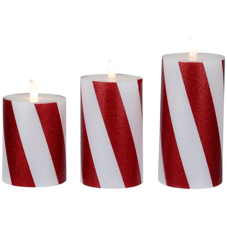 three candles with red and white stripes on them