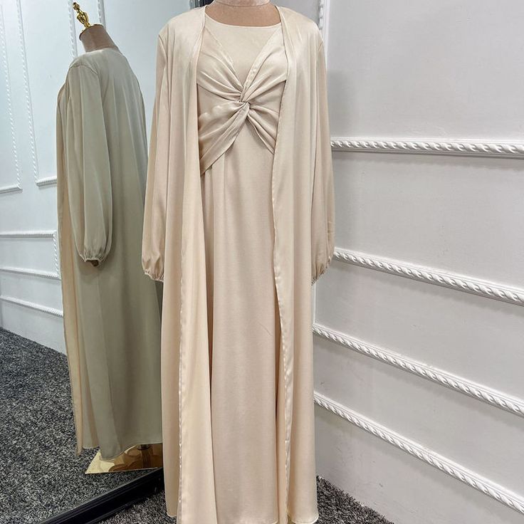 This Lux Two Piece Set is made from high-quality satin, and includes a long sleeve inner dress with chest design and a long sleeve open abaya in a matching color. Available in 6 beautiful colors. Elegant Solid Color Abaya For Fall, Elegant Solid Abaya For Fall, Elegant Long Sleeve Abaya For Spring, Solid Long Sleeve Dresses For Eid, Evening Solid Color Maxi Length Abaya, Evening Solid Maxi Length Abaya, Formal Spring Abaya With Long Sleeves, Spring Formal Long Sleeve Abaya, Evening Maxi Length Solid Abaya