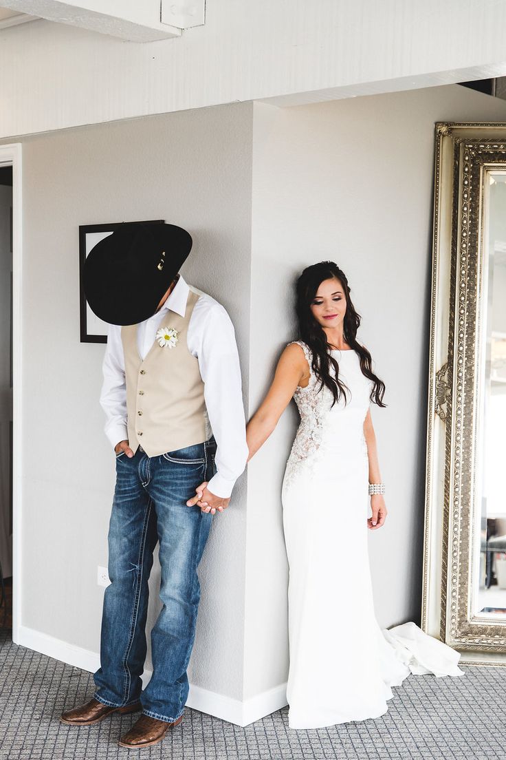 a man standing next to a woman in a white dress