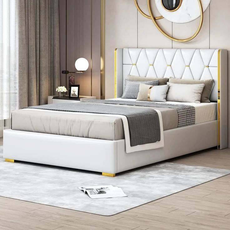 a white bed sitting in a bedroom on top of a hard wood floor