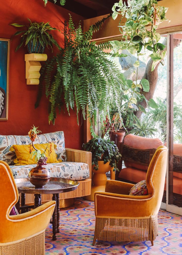 a living room filled with lots of furniture and plants