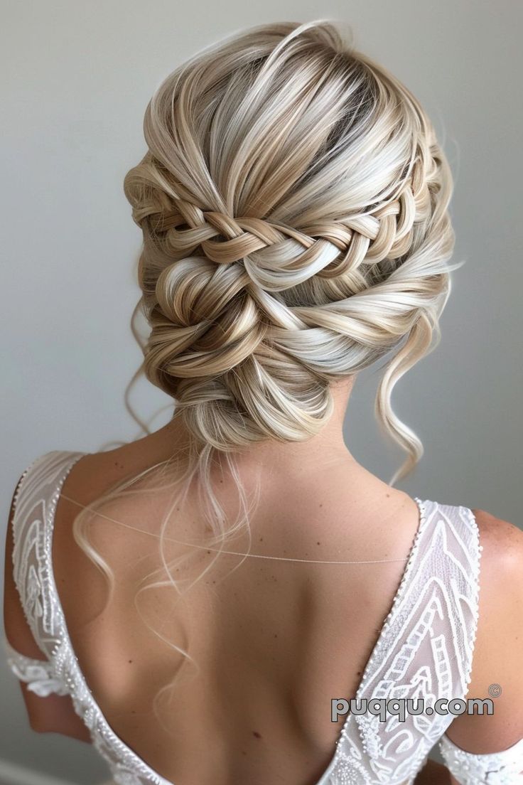 the back of a woman's head with blonde hair in a low bun braid