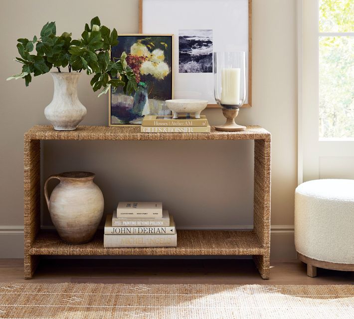 a table with books, vases and candles on it