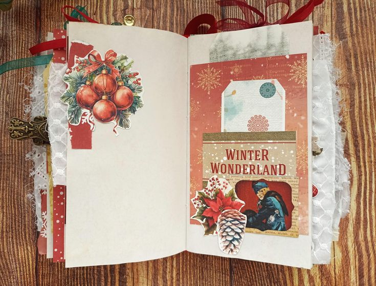 an open christmas card book sitting on top of a wooden table